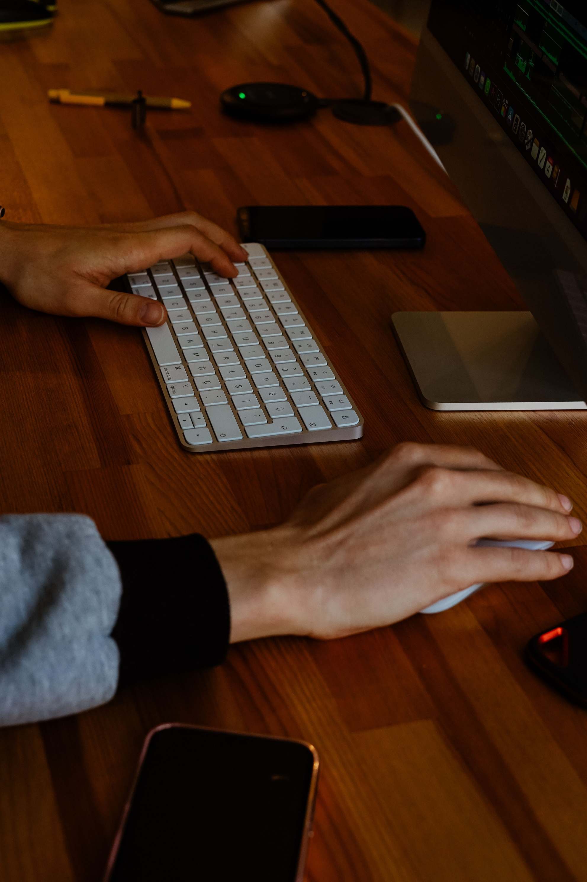 Developer workstation with code visible on a monitor beside a keyboard